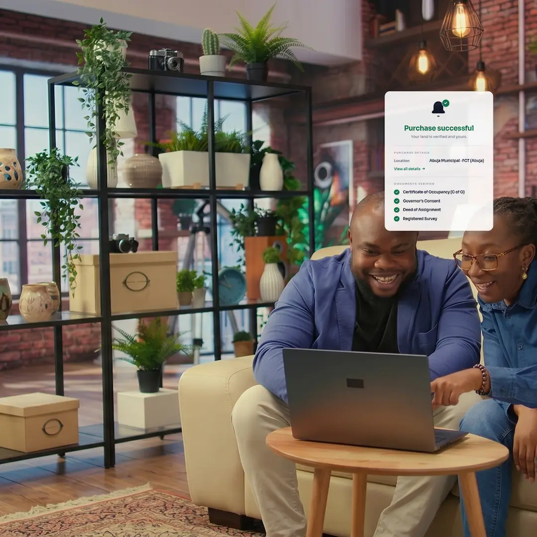 A couple reviewing their land purchase confirmation, with verified documents listed in the success notification